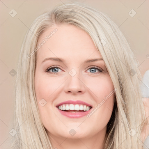 Joyful white young-adult female with long  brown hair and blue eyes