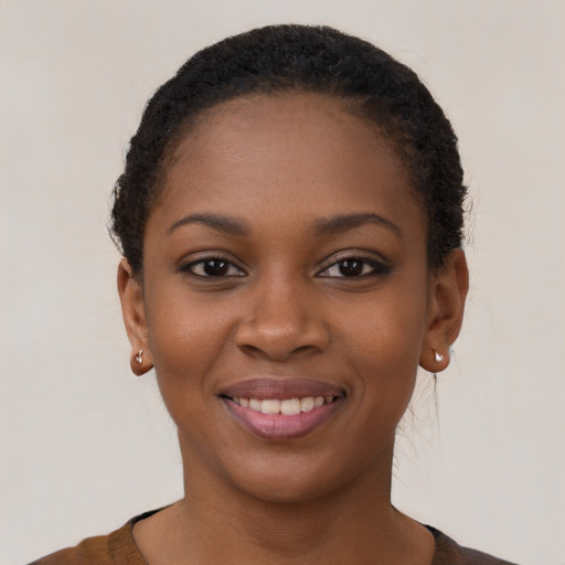 Joyful black young-adult female with short  brown hair and brown eyes