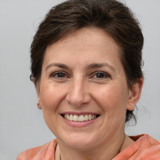 Joyful white adult female with medium  brown hair and brown eyes