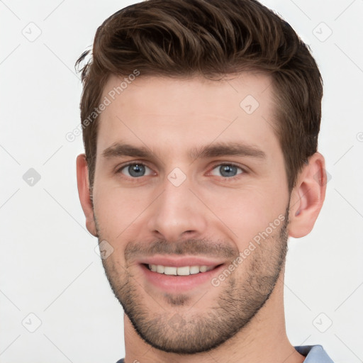 Joyful white young-adult male with short  brown hair and grey eyes