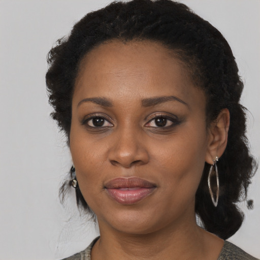 Joyful black young-adult female with medium  black hair and brown eyes
