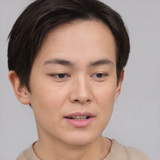 Joyful asian young-adult female with short  brown hair and brown eyes