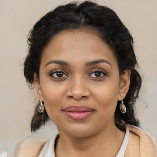 Joyful black young-adult female with medium  brown hair and brown eyes