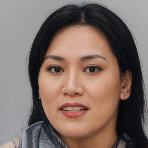Joyful asian young-adult female with long  black hair and brown eyes