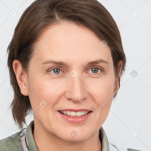 Joyful white adult female with medium  brown hair and grey eyes