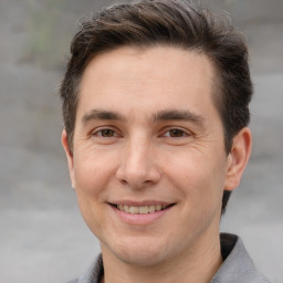 Joyful white adult male with short  brown hair and brown eyes