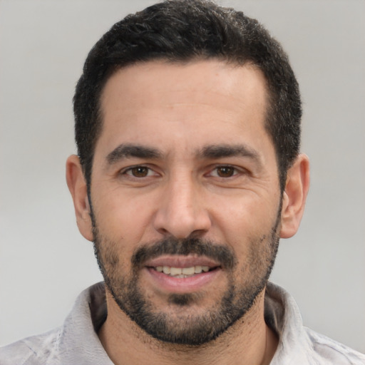 Joyful white young-adult male with short  black hair and brown eyes