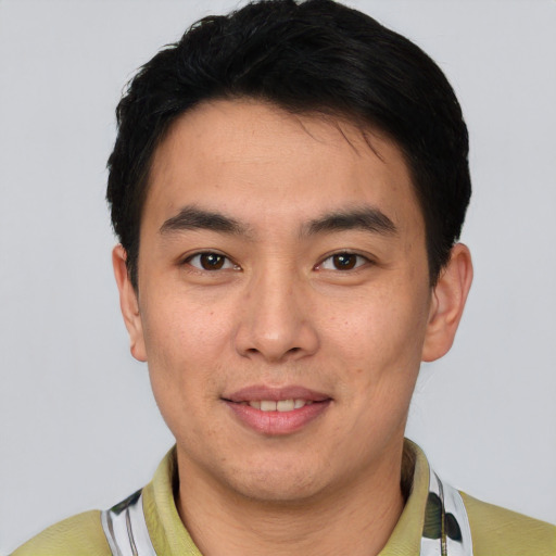Joyful white young-adult male with short  black hair and brown eyes