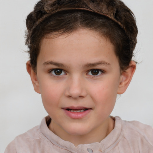 Joyful white child female with short  brown hair and brown eyes