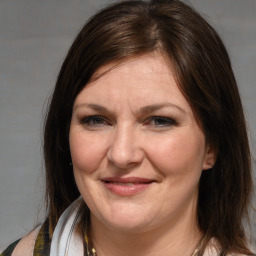 Joyful white adult female with medium  brown hair and brown eyes