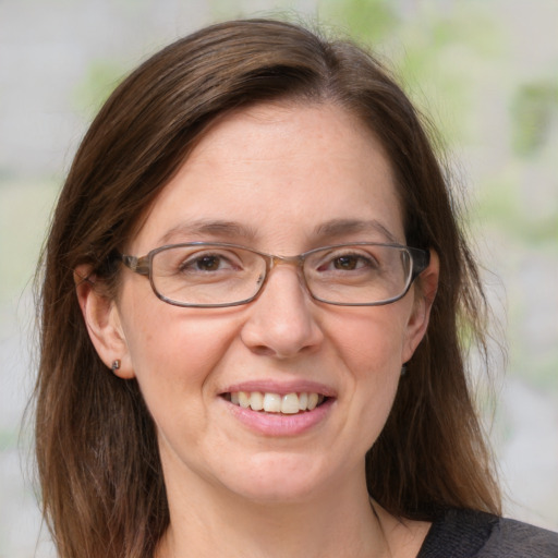 Joyful white adult female with medium  brown hair and blue eyes