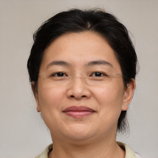 Joyful asian adult female with medium  brown hair and brown eyes
