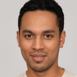 Joyful latino young-adult male with short  black hair and brown eyes