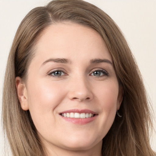 Joyful white young-adult female with long  brown hair and grey eyes