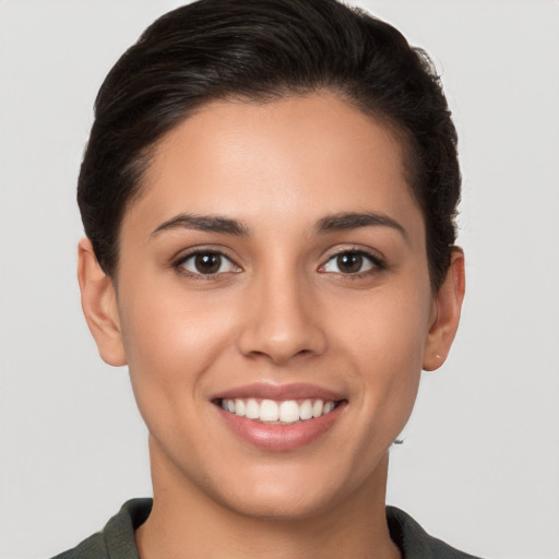 Joyful white young-adult female with short  brown hair and brown eyes