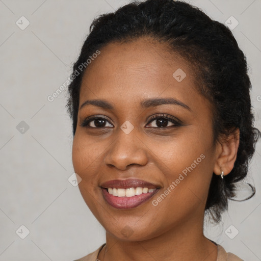 Joyful black young-adult female with medium  brown hair and brown eyes