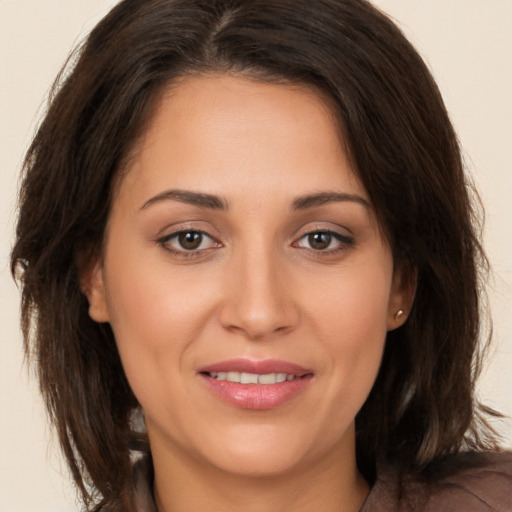 Joyful white young-adult female with medium  brown hair and brown eyes