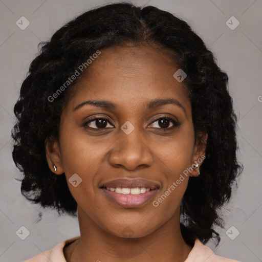 Joyful black young-adult female with medium  black hair and brown eyes