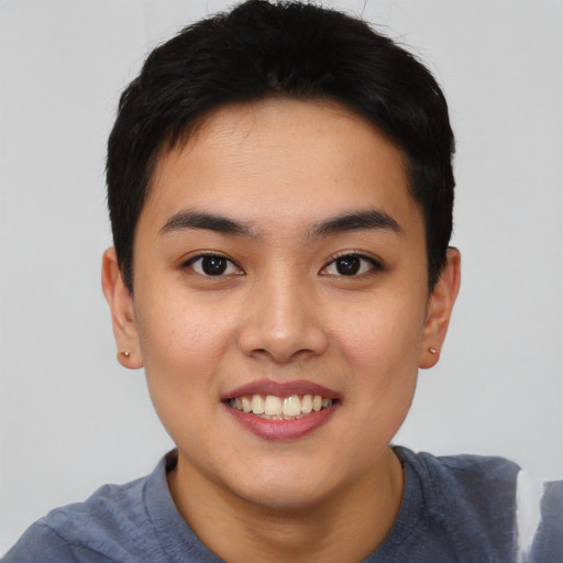 Joyful asian young-adult male with short  black hair and brown eyes