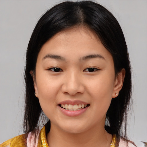 Joyful asian young-adult female with medium  brown hair and brown eyes