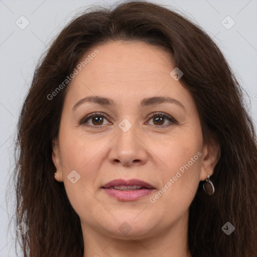 Joyful white adult female with long  brown hair and brown eyes