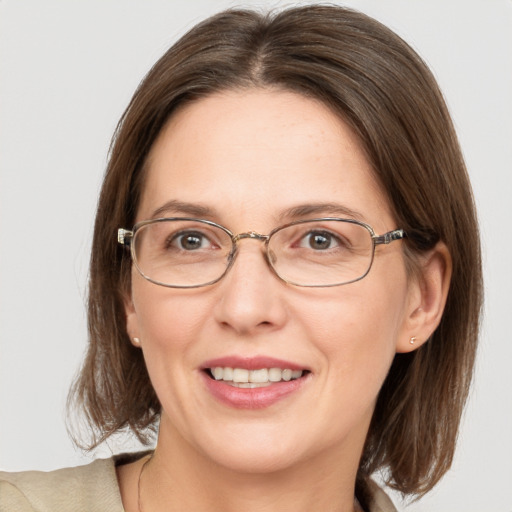 Joyful white adult female with medium  brown hair and blue eyes