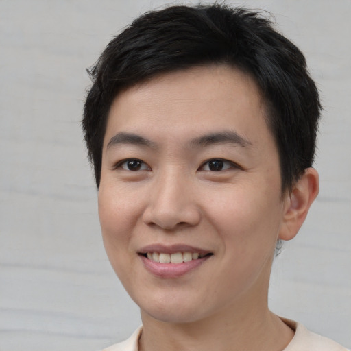 Joyful asian young-adult male with short  brown hair and brown eyes