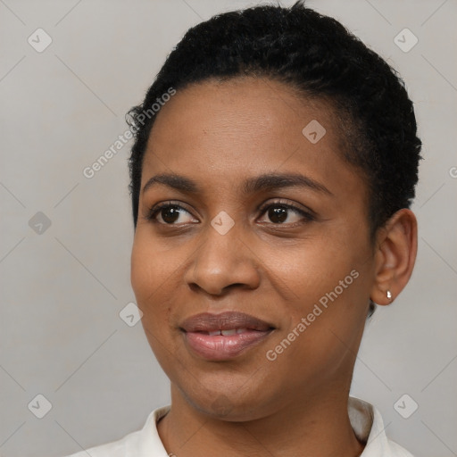 Joyful black young-adult female with short  black hair and brown eyes