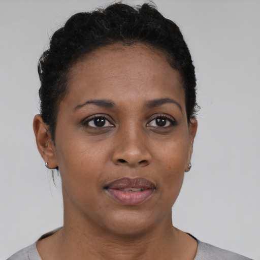 Joyful black young-adult female with short  brown hair and brown eyes