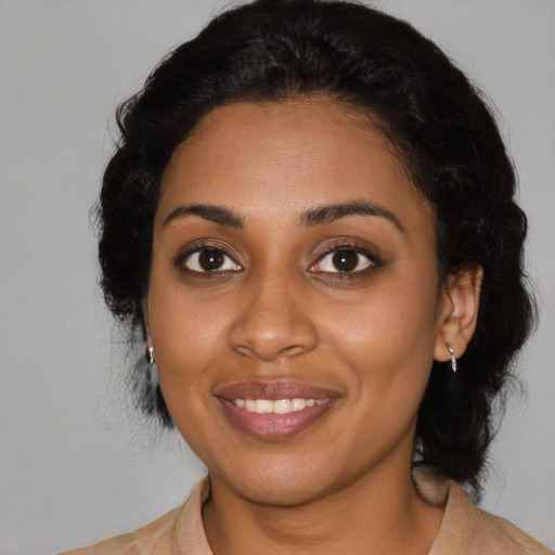 Joyful black young-adult female with medium  black hair and brown eyes