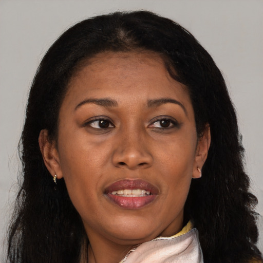 Joyful black adult female with long  brown hair and brown eyes