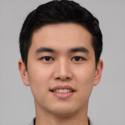 Joyful asian young-adult male with short  black hair and brown eyes