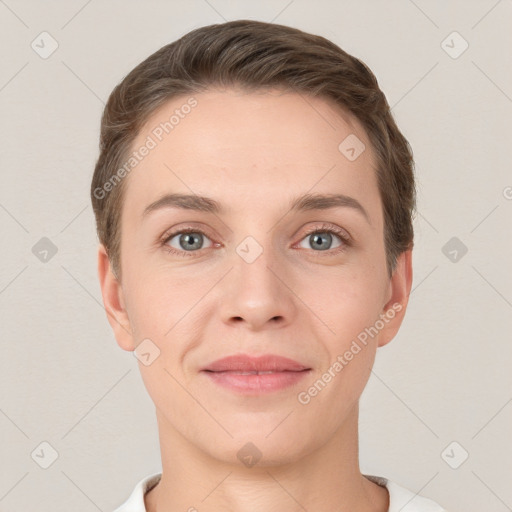 Joyful white young-adult female with short  brown hair and grey eyes