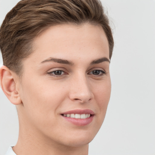 Joyful white young-adult female with short  brown hair and grey eyes