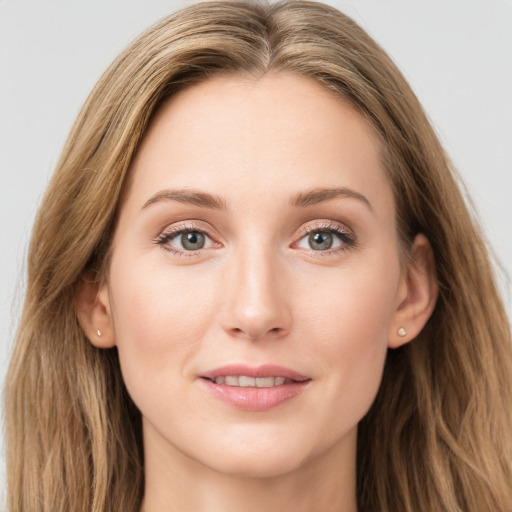 Joyful white young-adult female with long  brown hair and blue eyes