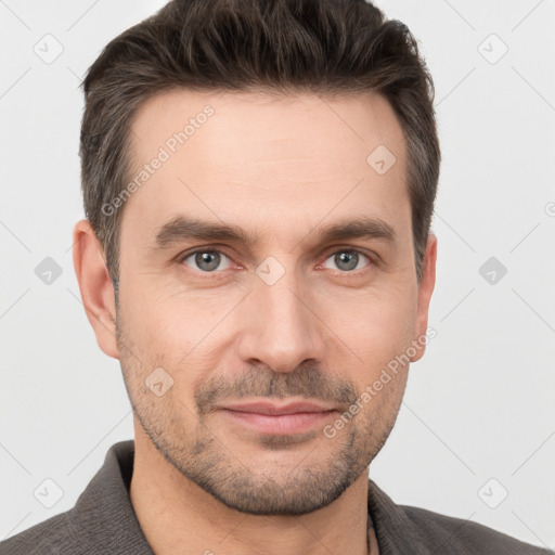 Joyful white adult male with short  brown hair and brown eyes