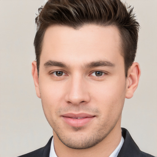 Joyful white young-adult male with short  brown hair and brown eyes