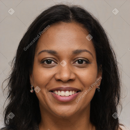 Joyful black young-adult female with long  brown hair and brown eyes