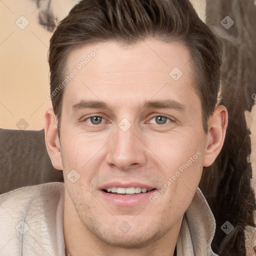 Joyful white adult male with short  brown hair and grey eyes