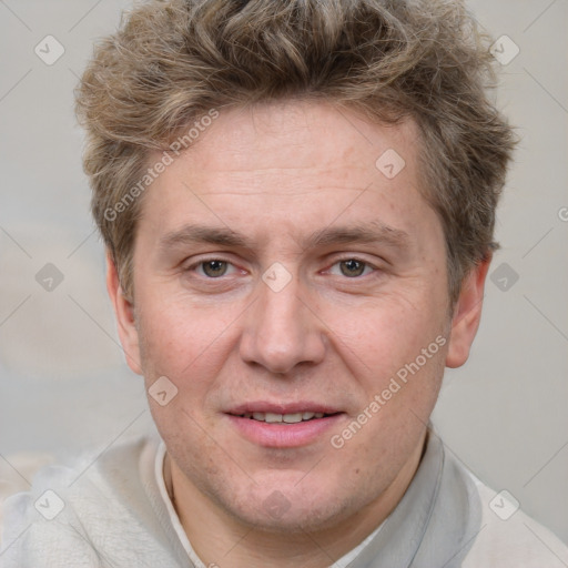 Joyful white adult male with short  brown hair and grey eyes