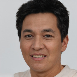 Joyful white adult male with short  black hair and brown eyes