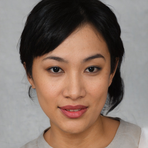 Joyful asian young-adult female with medium  black hair and brown eyes