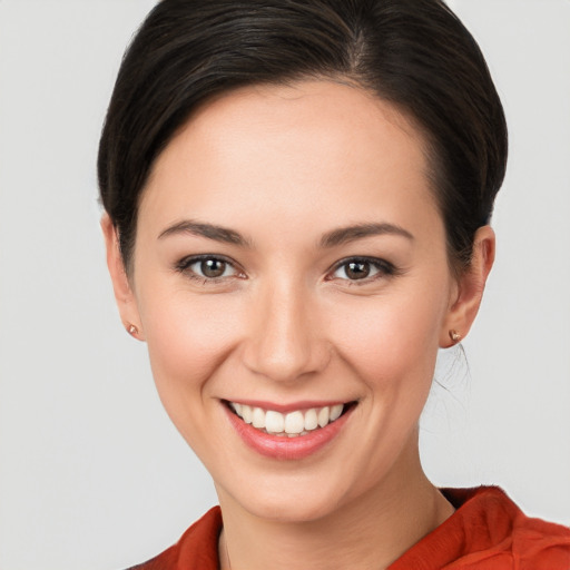 Joyful white young-adult female with medium  brown hair and brown eyes