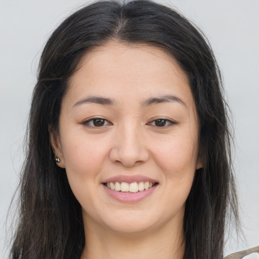 Joyful white young-adult female with long  brown hair and brown eyes
