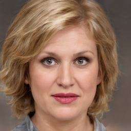 Joyful white adult female with medium  brown hair and blue eyes