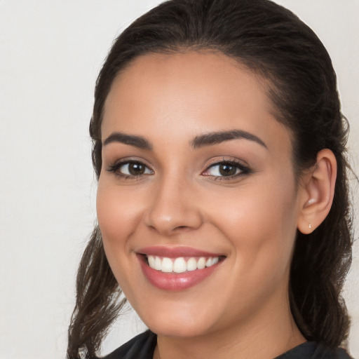 Joyful white young-adult female with long  brown hair and brown eyes