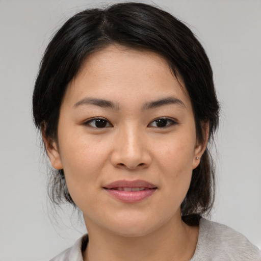 Joyful asian young-adult female with medium  brown hair and brown eyes