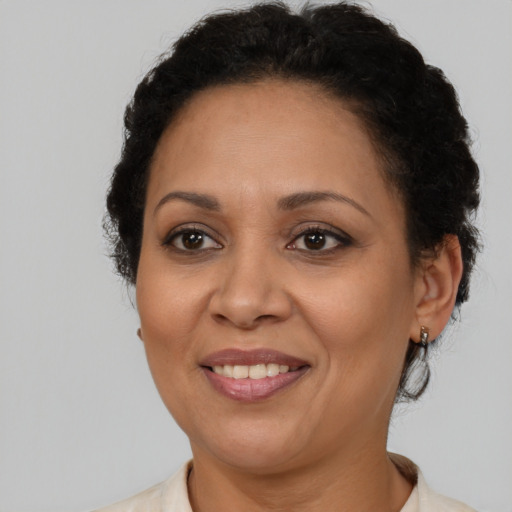 Joyful latino adult female with short  brown hair and brown eyes