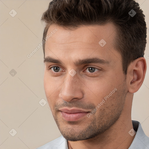 Joyful white young-adult male with short  brown hair and brown eyes