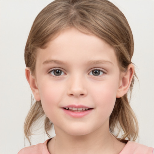 Joyful white child female with medium  brown hair and grey eyes